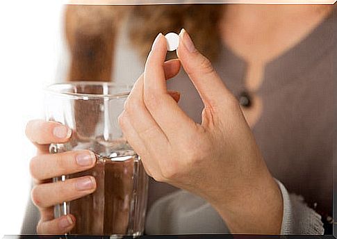 Woman taking antipyretic