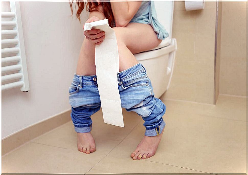 Woman on the toilet bowl with chronic or acute diarrhea.