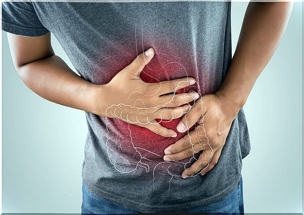 Man with hands on abdomen with pain.