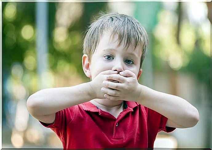 Child covering his mouth