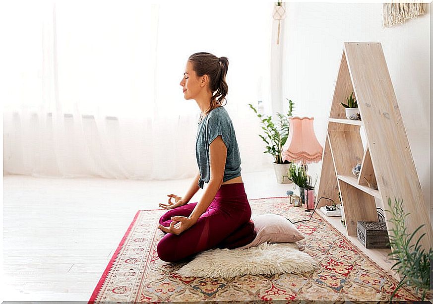 Woman practicing meditation at home.