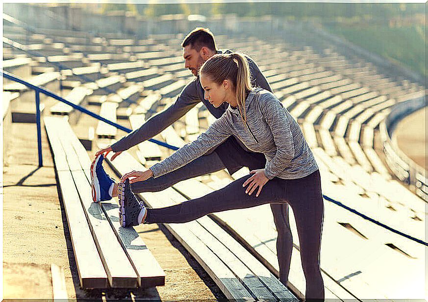 Couple performs stretches to go for a run.